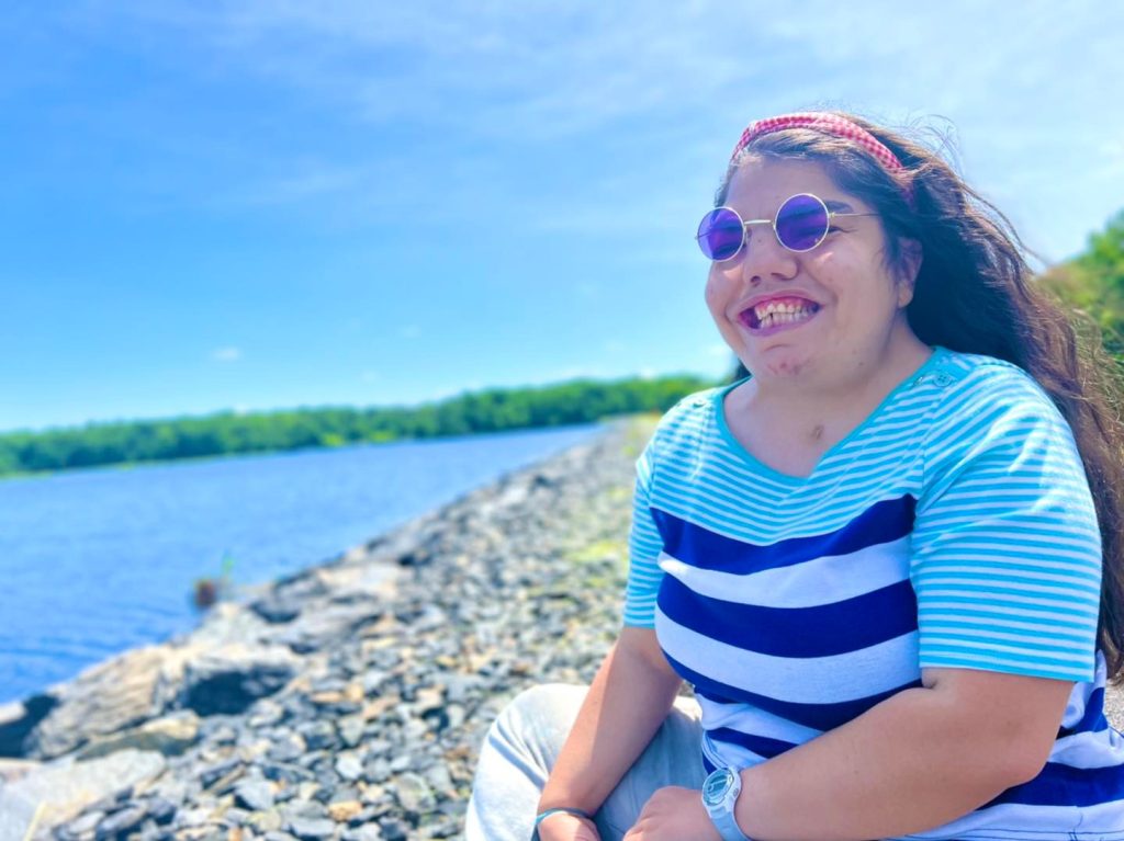 Woman smiling near body of water